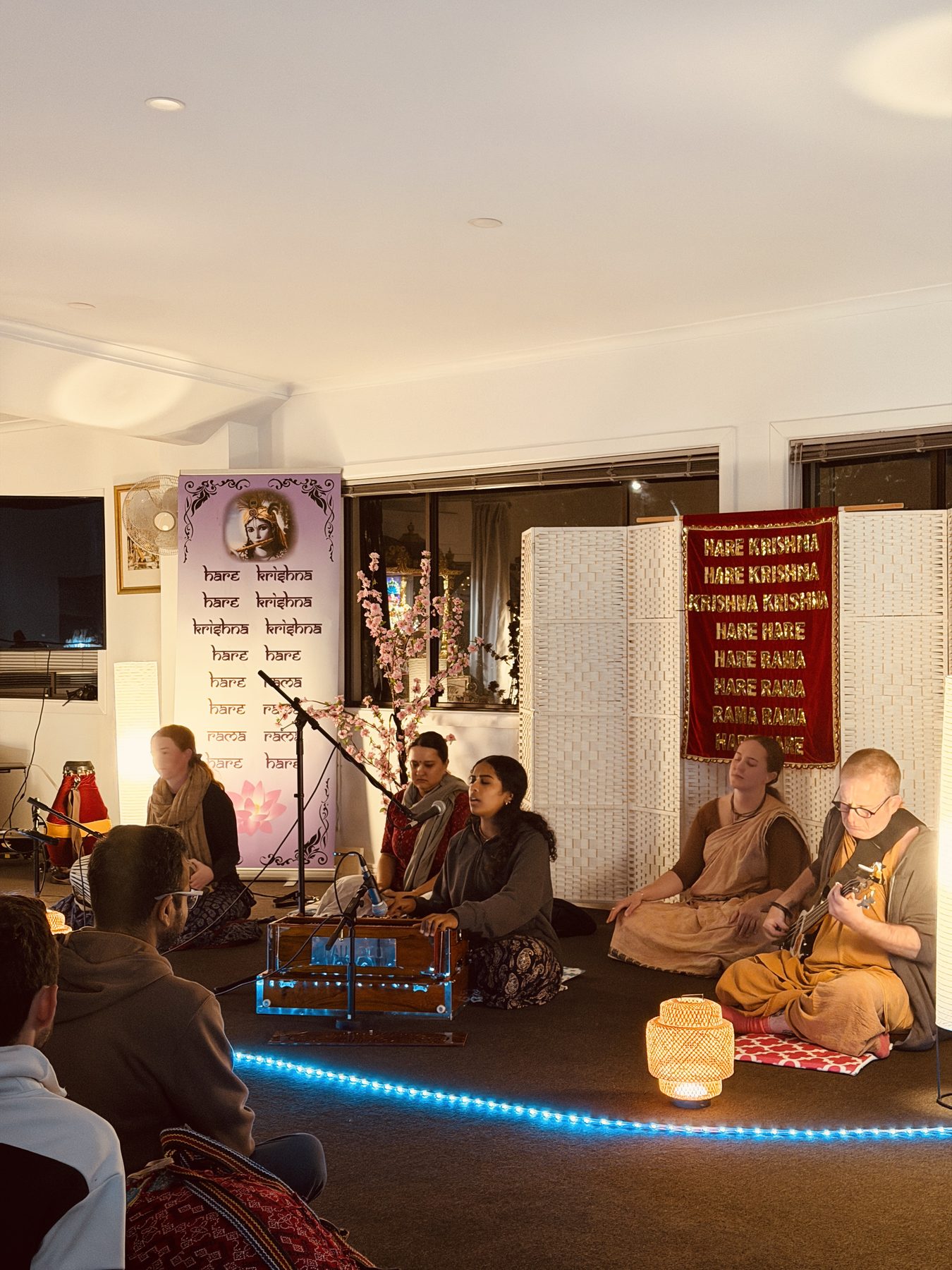 A group of people taking part in a kirtan session