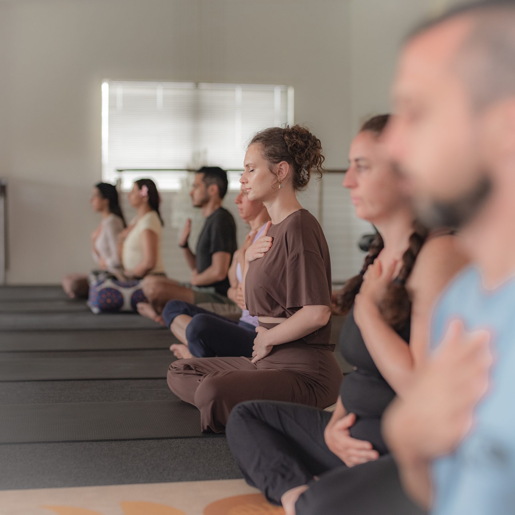A group of people practising yoga in the studio