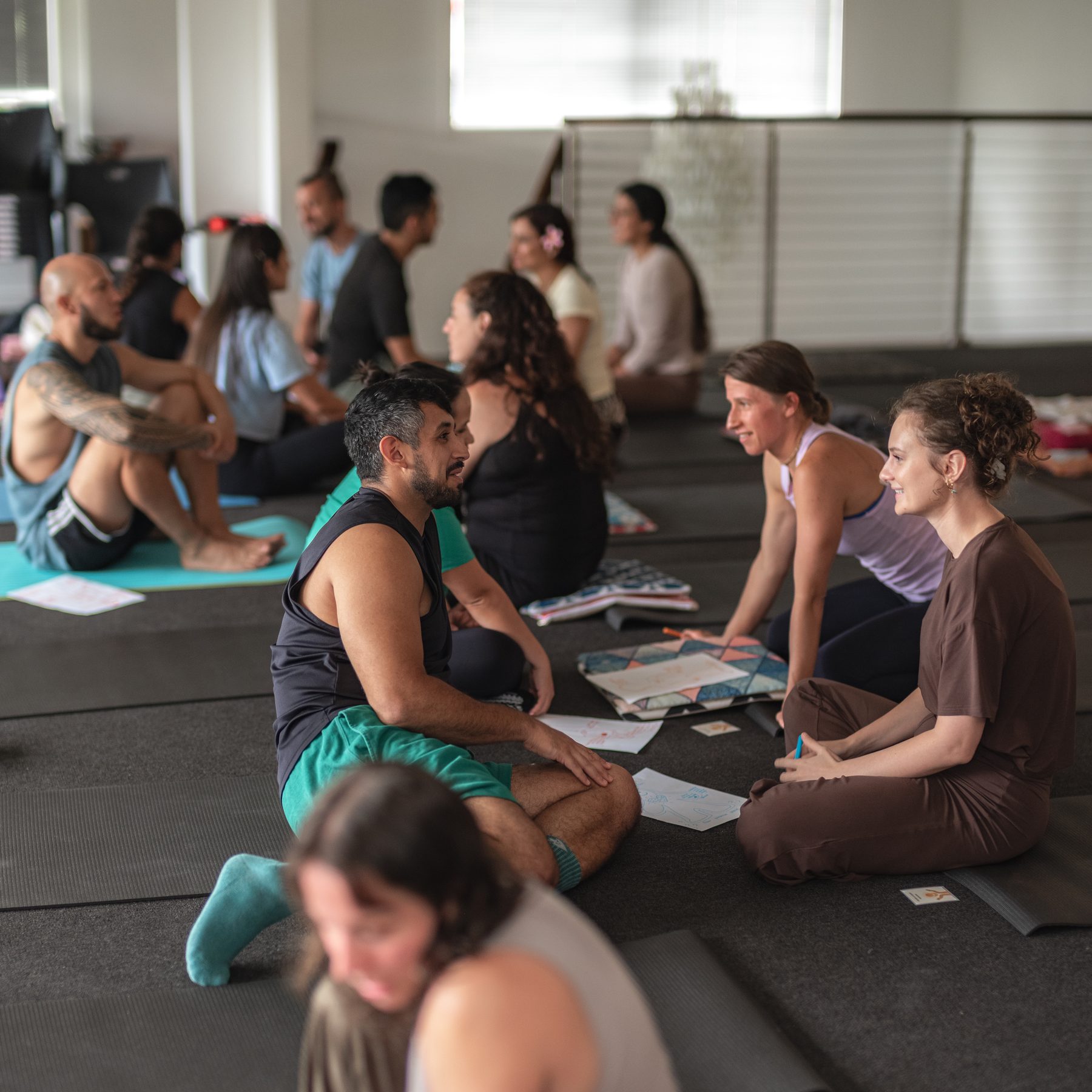 A group of people sitting together in the yoga studio