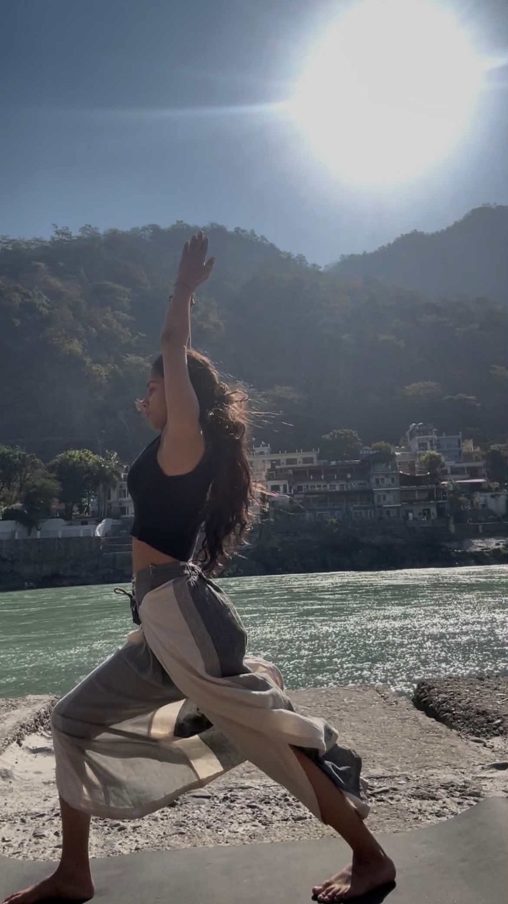 Muskan Verma performing a yoga pose by a river