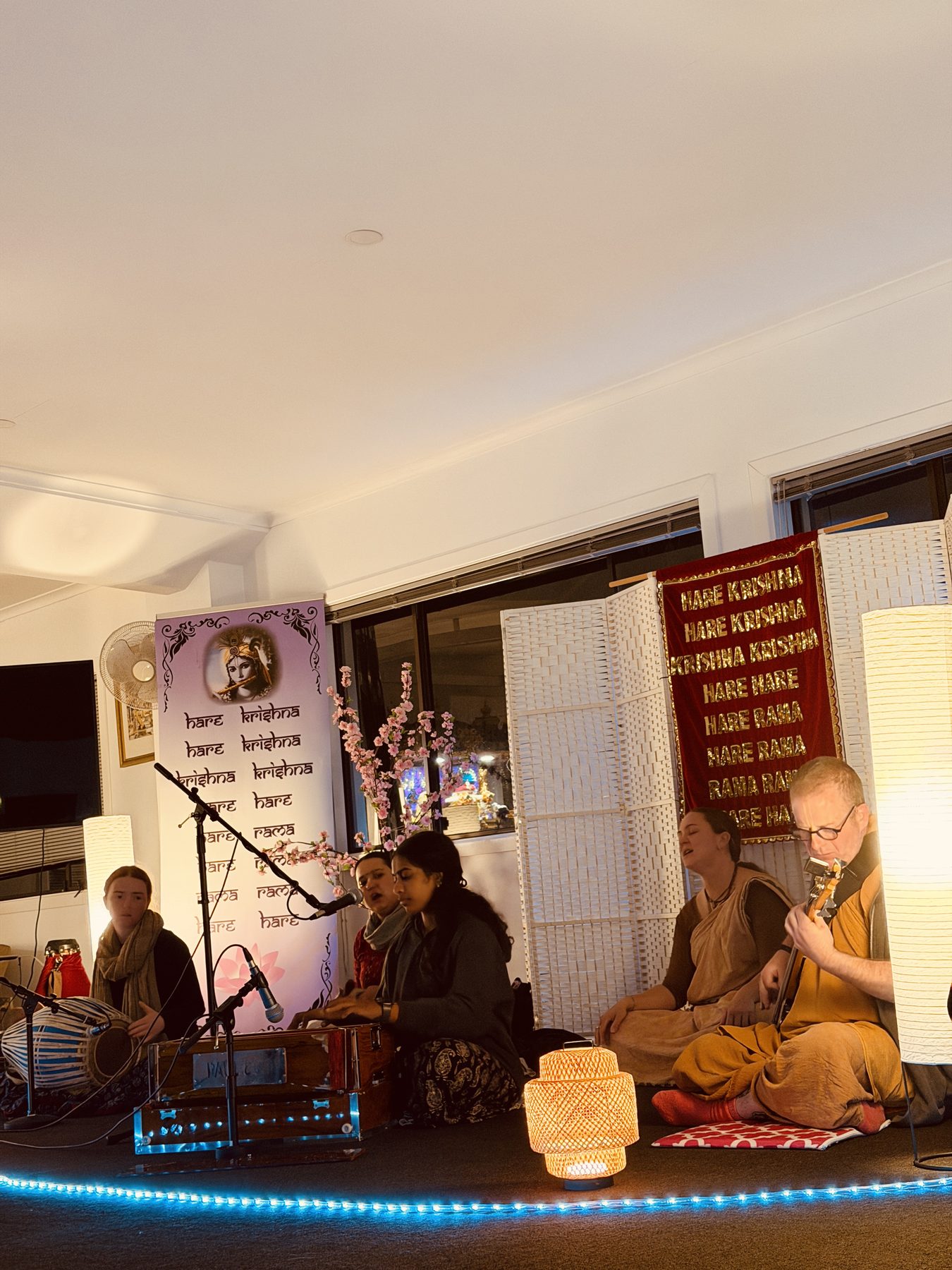 A group of people performing kirtan together