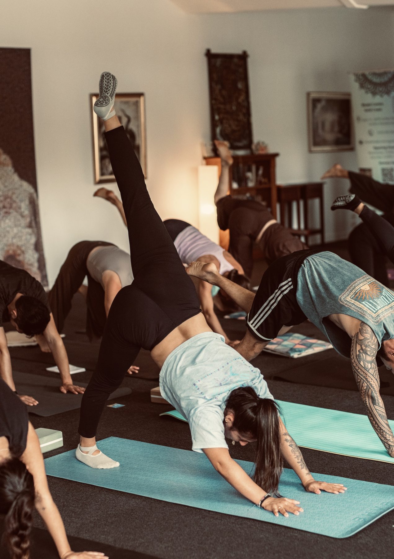 A group of people practising yoga postures in the studio