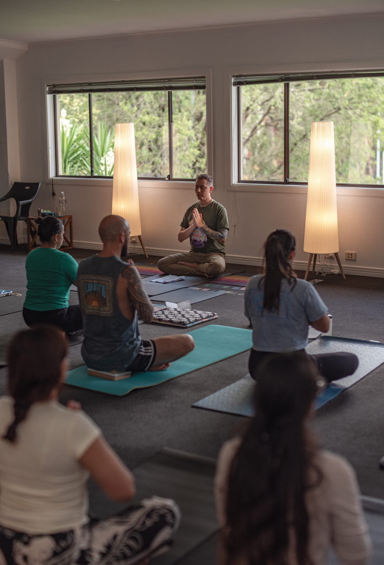 A group of people resting quietly in the yoga studio