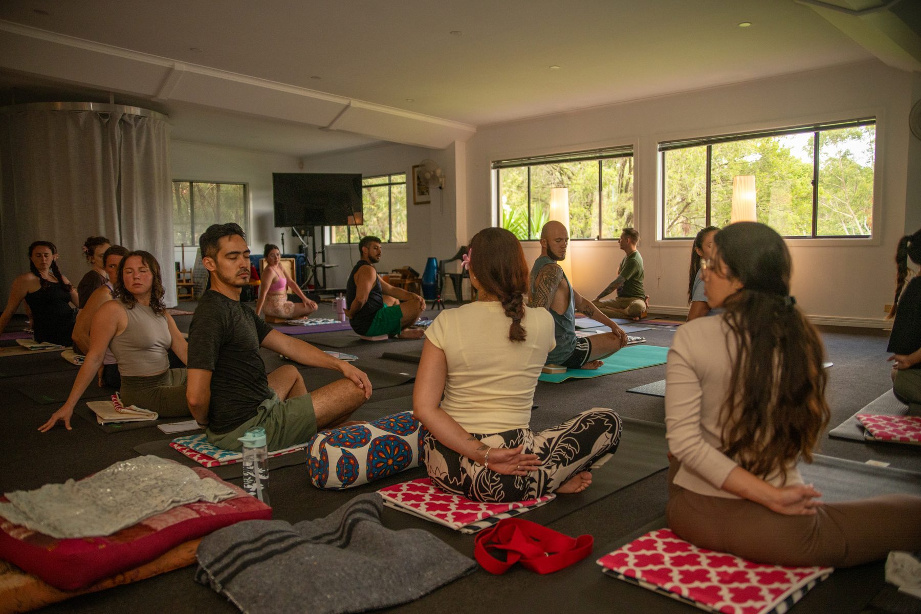 A group of people sitting together in the yoga studio